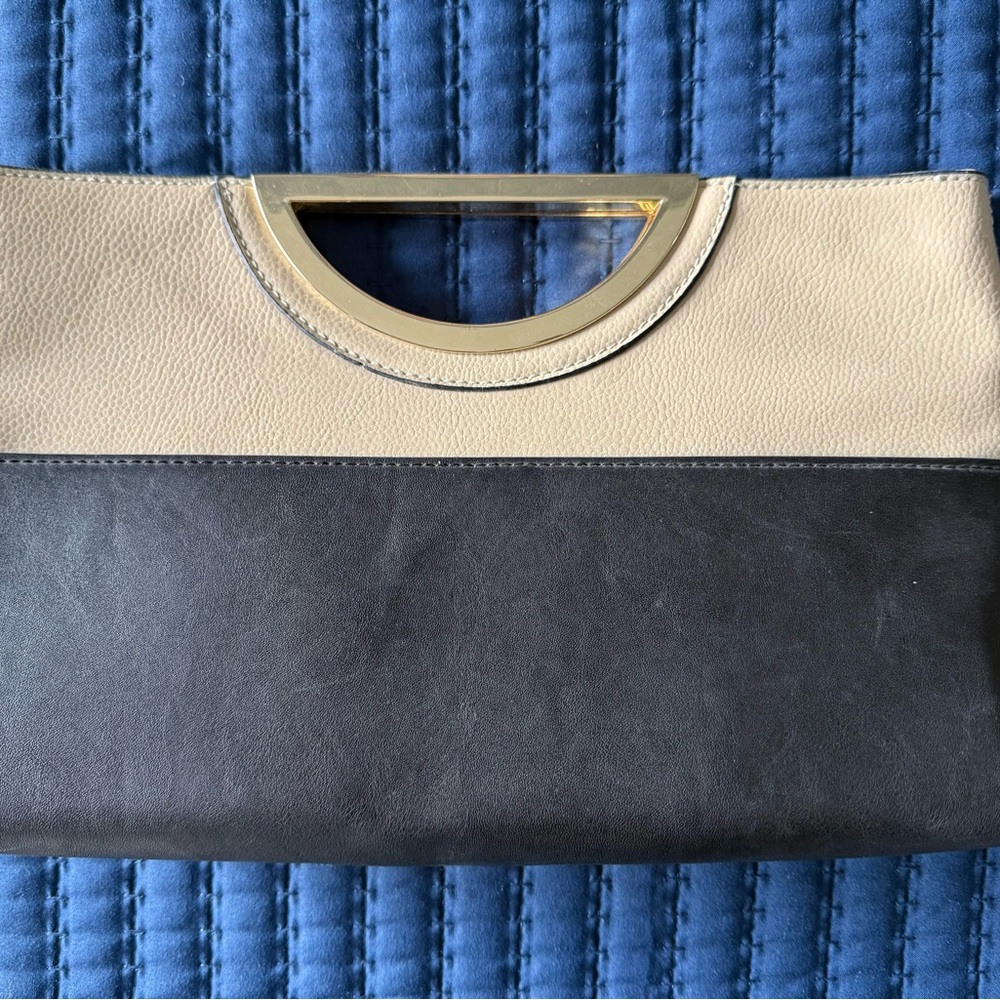 The Limited Black and Cream Clutch with Elegant Design